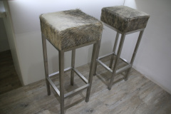 grey and white cowhide stools