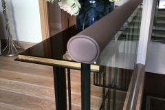 Brown leather handrail on glass balustrade