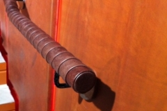 Tennis racket style wrapped leather handrail