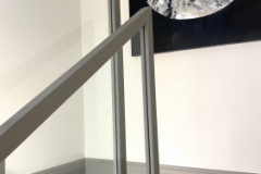 Bespoke handrail for glass balustrade covered in leather and fit on-site.